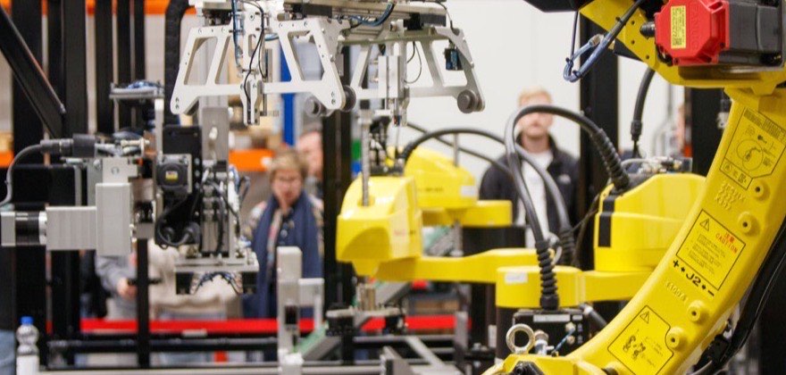 Industrial robotic arm working on a vehicle assembly line