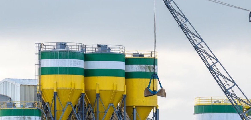 Crane and storage silos at a cement production plant